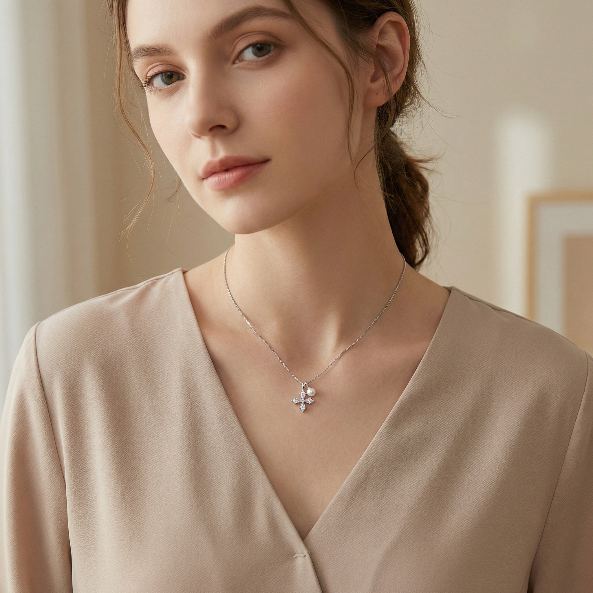 Elegant sterling silver cross necklace featuring CZ stones and pearl on a box chain