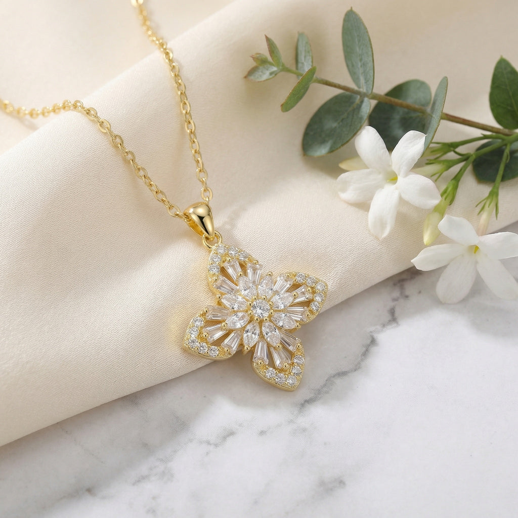 Floral cross pendant featuring marquise and baguette-cut crystals on adjustable chain in sterling silver