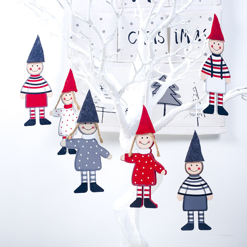 Wooden Christmas tree ornaments with boy and girl designs on a festive background Main image