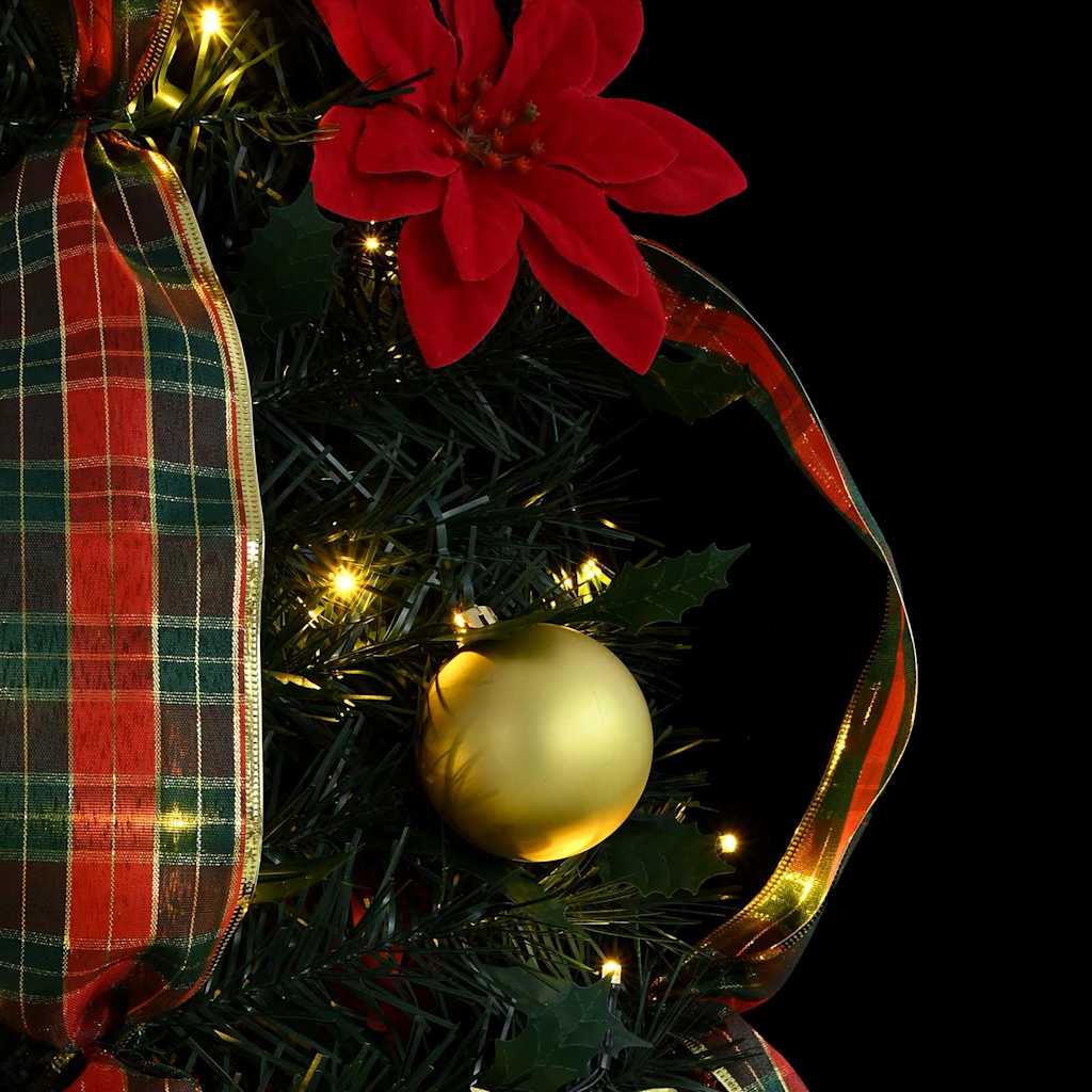 Green artificial Christmas tree with warm white LED lights for holiday display