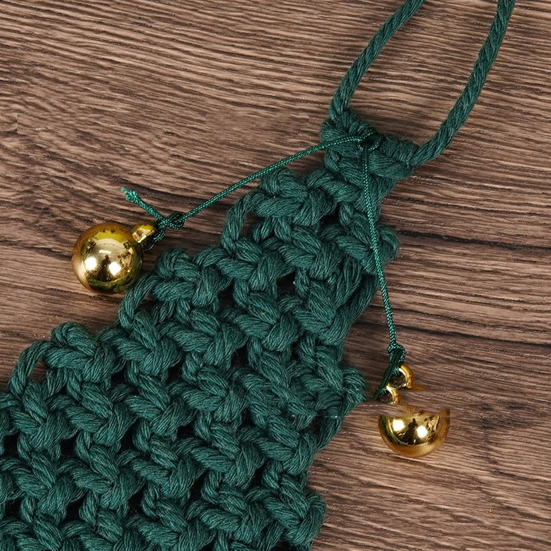 Close-up of hand-woven cotton string texture on green Christmas tree pendant