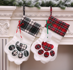 Dog paw Christmas stocking as tree decoration during holiday season
