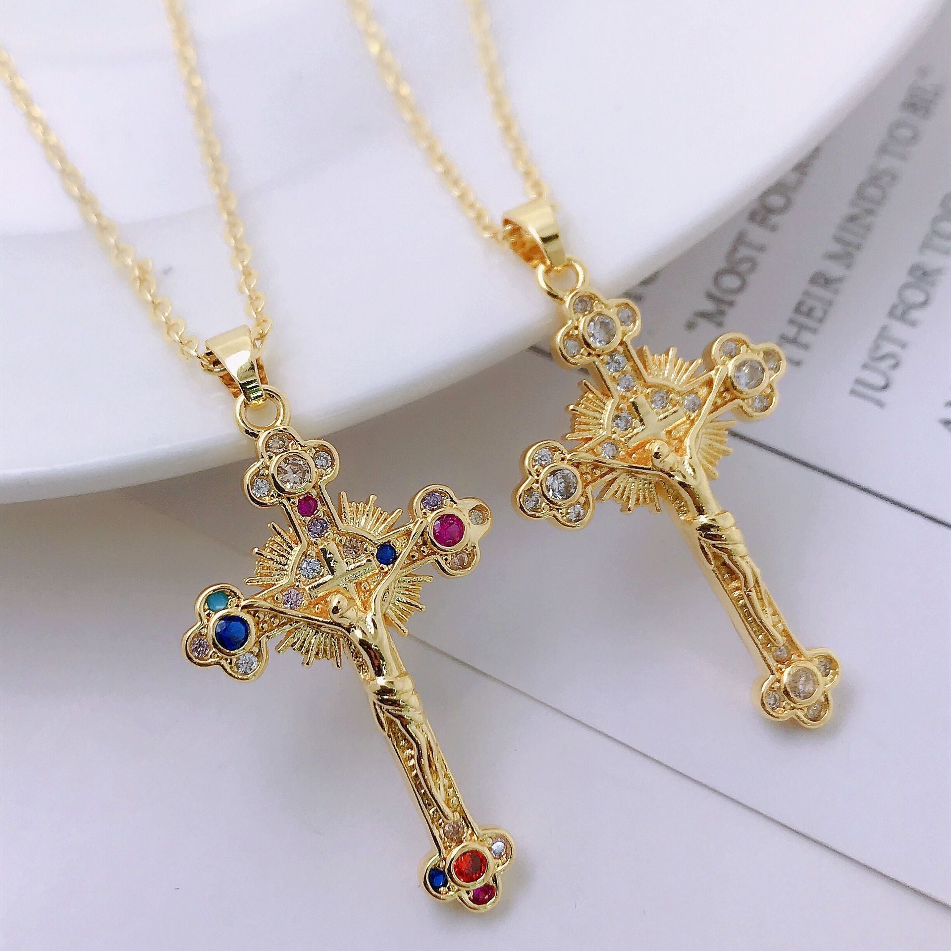 Front view of gold-tone oversized cross pendant necklace on mannequin