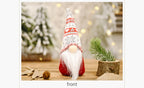 Forest doll Christmas ornament displayed on rustic wooden shelf with candle
