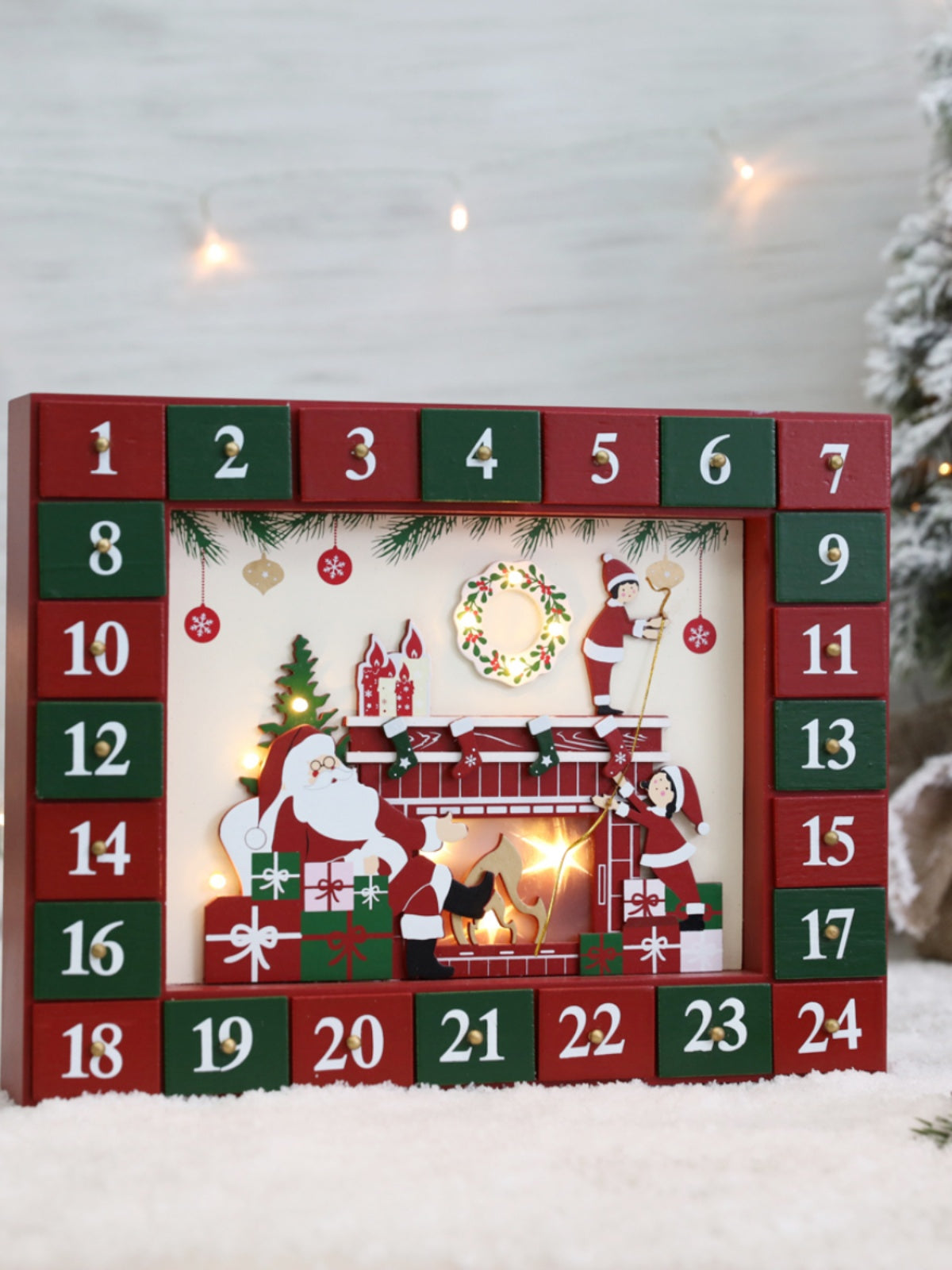 Wooden Advent countdown calendar cabinet with fireplace-style design, featuring multiple small drawers for daily surprises