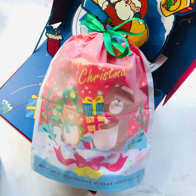 Japanese style Christmas bear drawstring gift bags laid out showing festive design