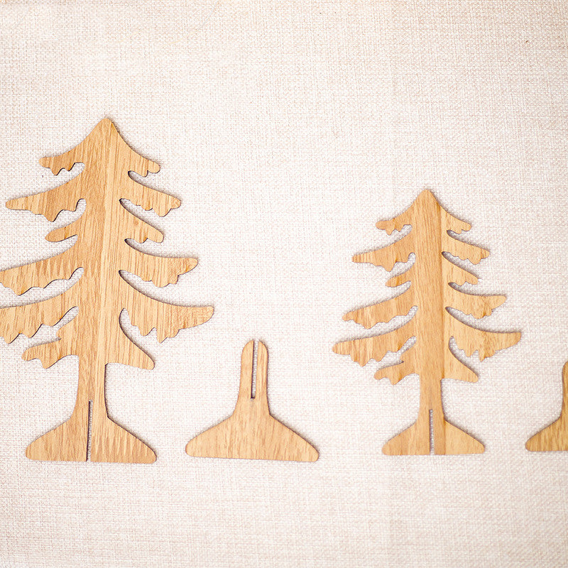 Multiple carved wooden Christmas ornaments showing variant designs and colors