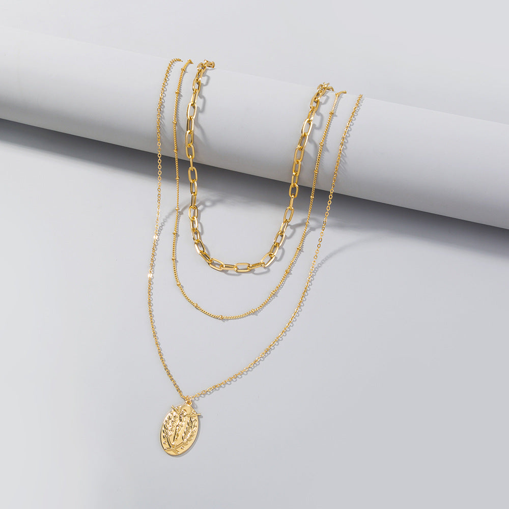 Elegant multi-layer faith necklace with geometric cross pendant detail