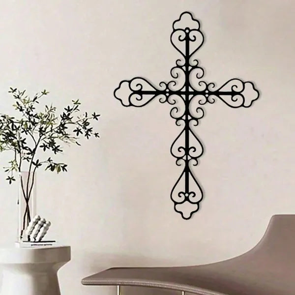 Black baked-paint metal cross artwork for wall display in living room setting
