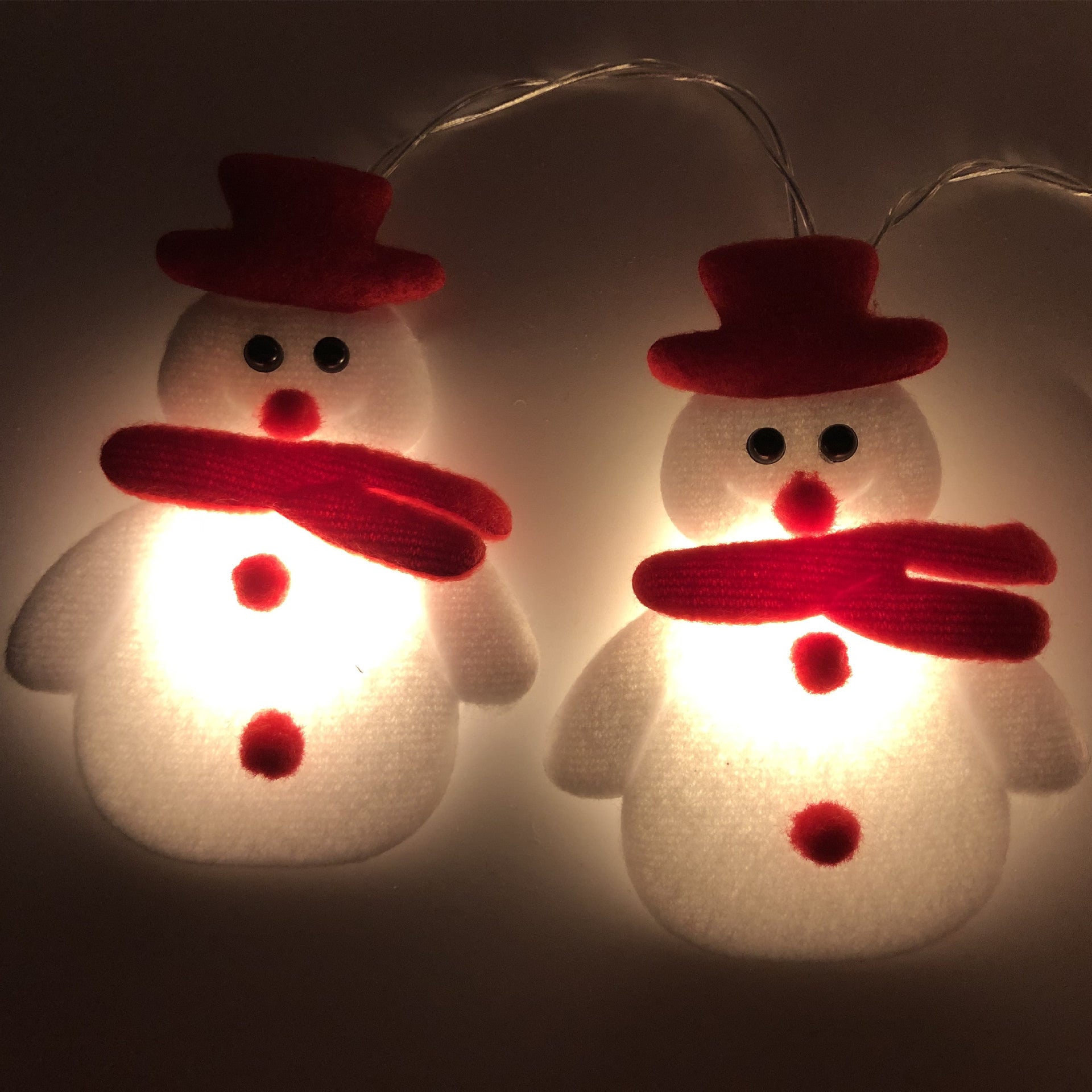 Plush snowman holiday string lights creating warm Christmas ambiance