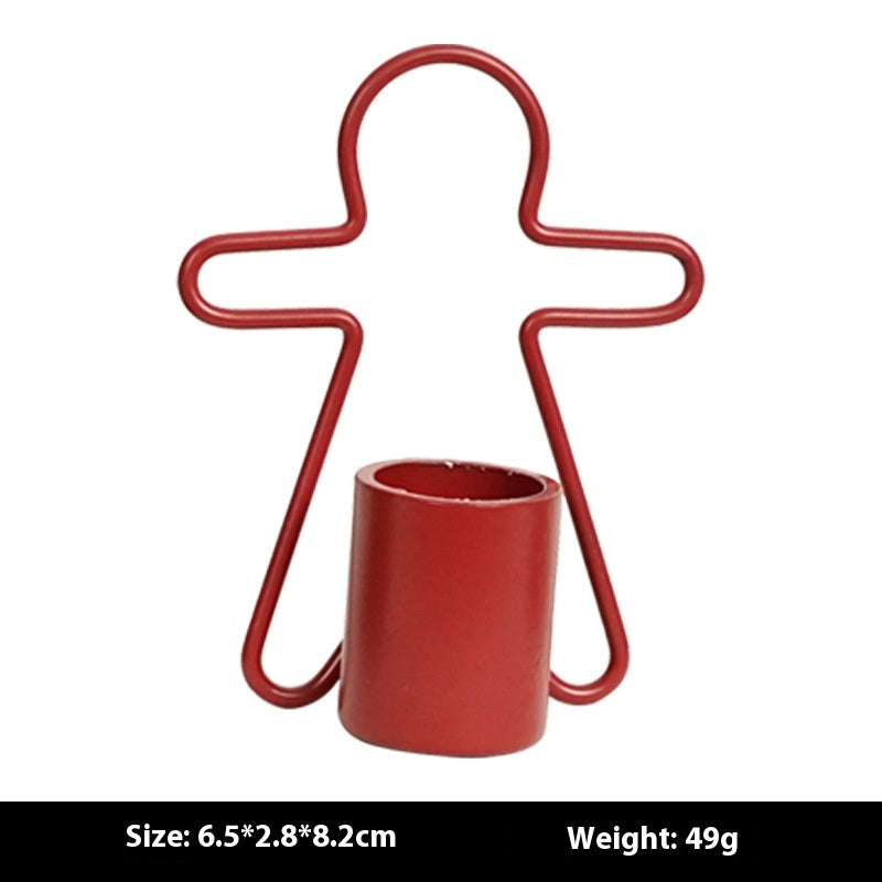 Holiday iron candlestick with gingerbread man motif