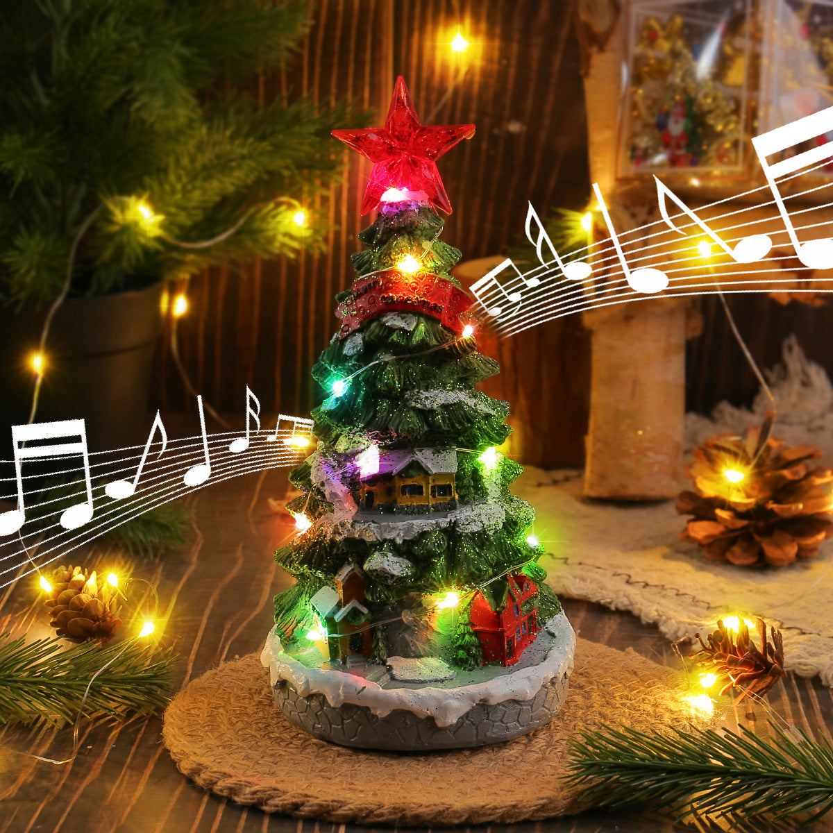 Light-up Christmas tree music box ornament with glowing lights on a shelf