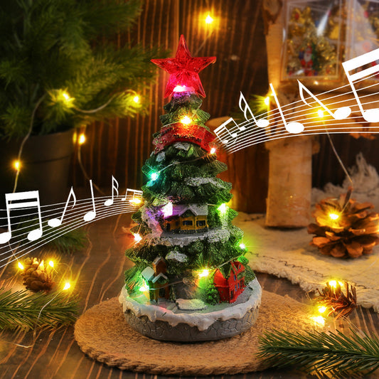 Light-up Christmas tree music box ornament with glowing lights on a shelf