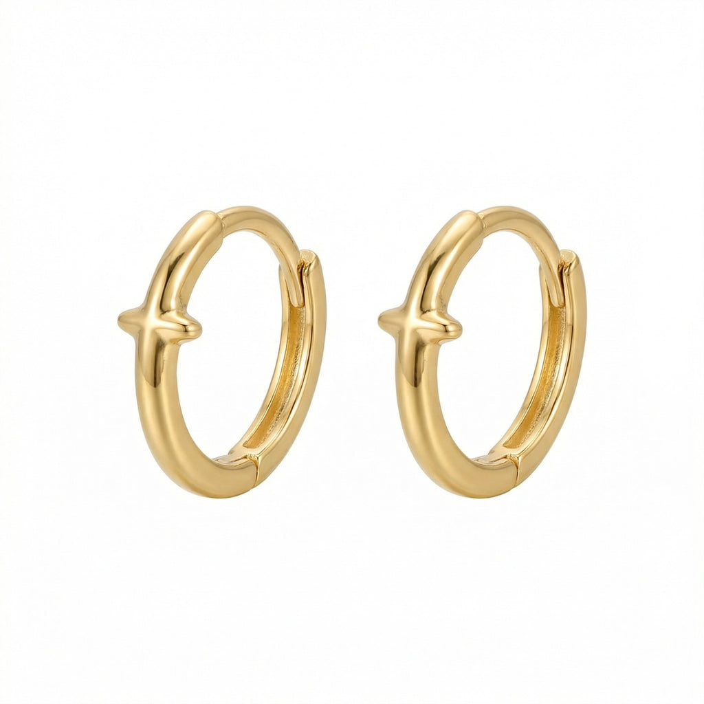 Christian cross huggie hoops displayed against light background