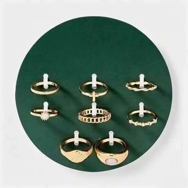 Assorted gold-tone rings from the 8-piece cross and sun set arranged together