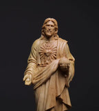 Elegant carved Jesus ornament displayed on decorative stand