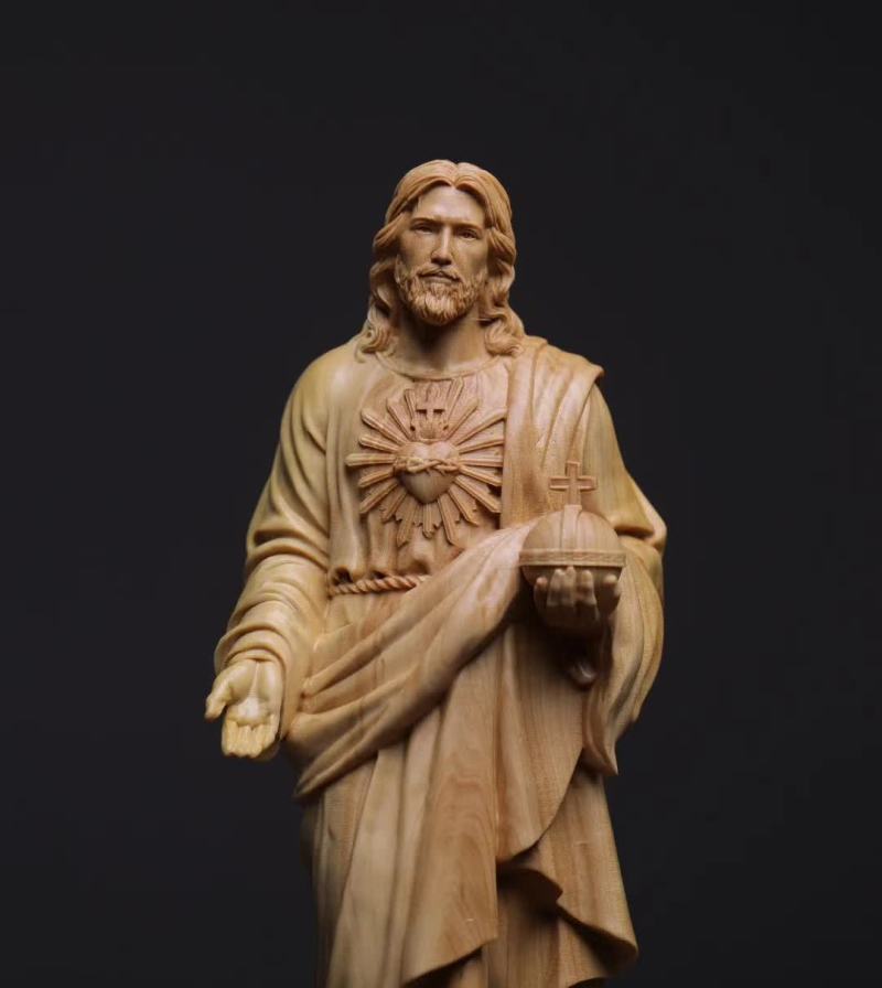 Elegant carved Jesus ornament displayed on decorative stand