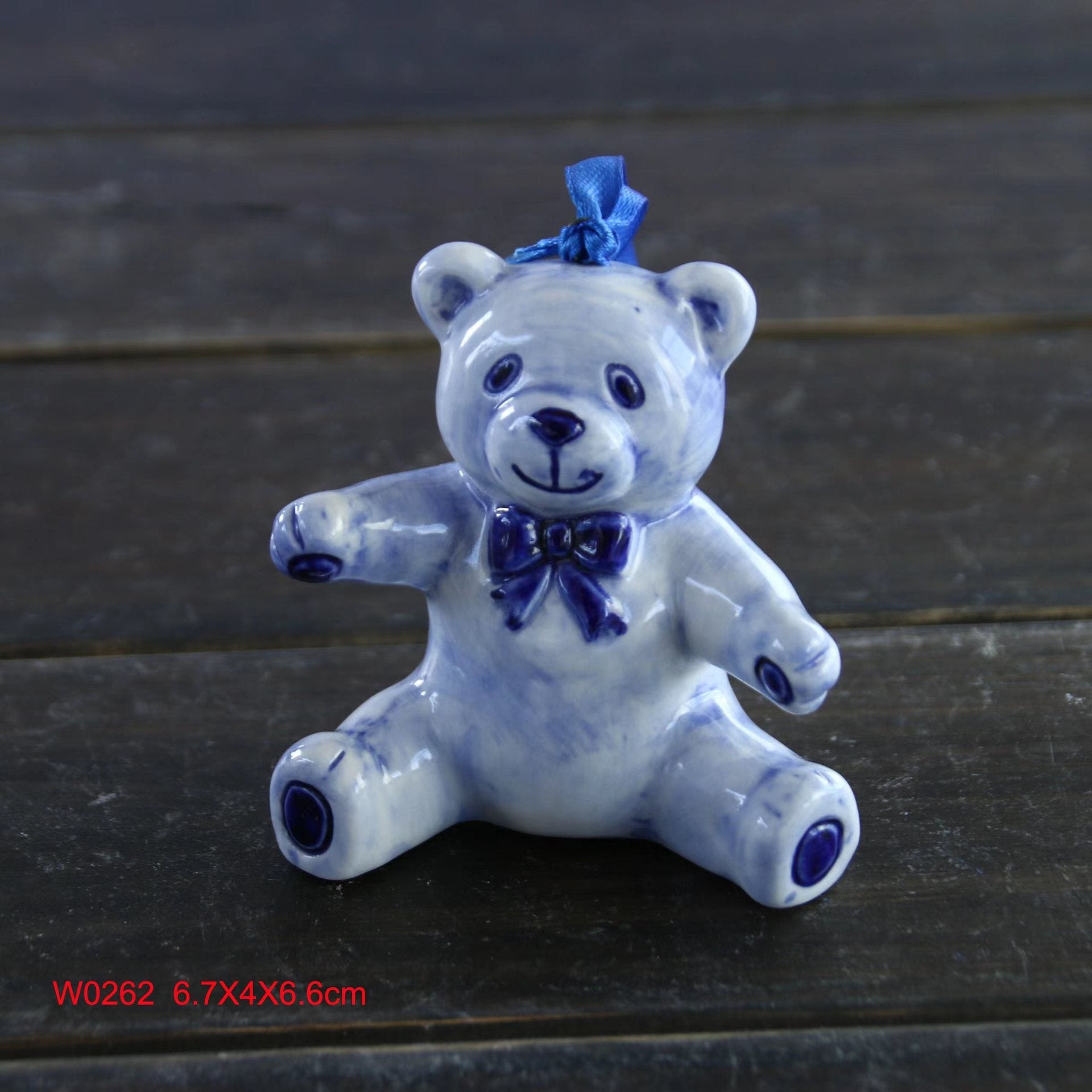 Blue and white porcelain Christmas tree ornament hanging on a tree
