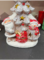 Christmas ornament featuring glowing ceramic houses in winter scene