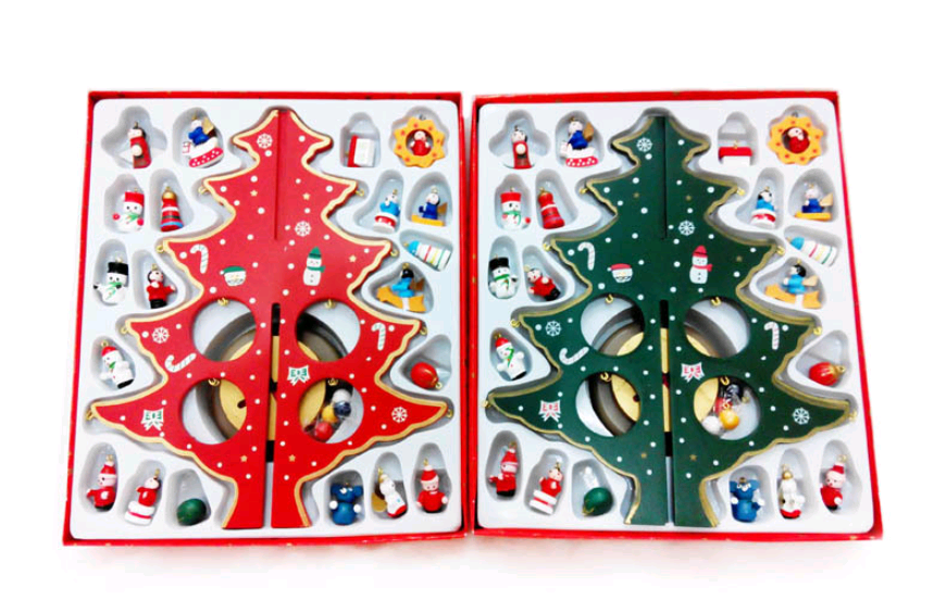 Red and green hand-painted wood Christmas tree on desktop with holiday greenery