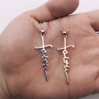 Multiple silver cross pendants arranged for product display