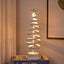 Warm white LED Christmas tree light on decorated surface with gentle glow
