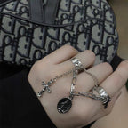 Stack of cross rings in vintage electroplated style showing collection variety