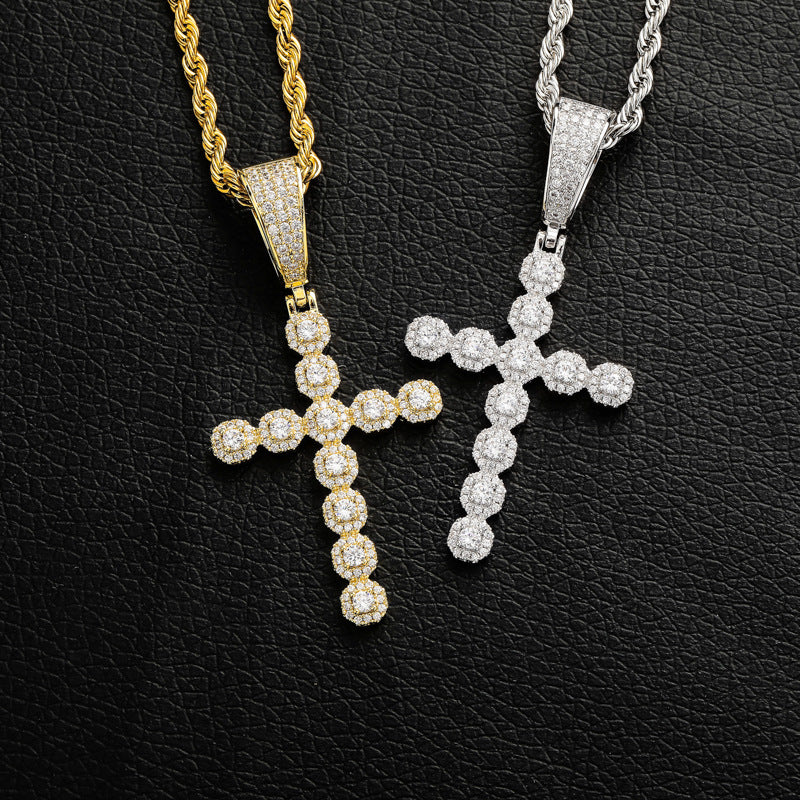 Close-up of zircon stones set in copper cross pendant