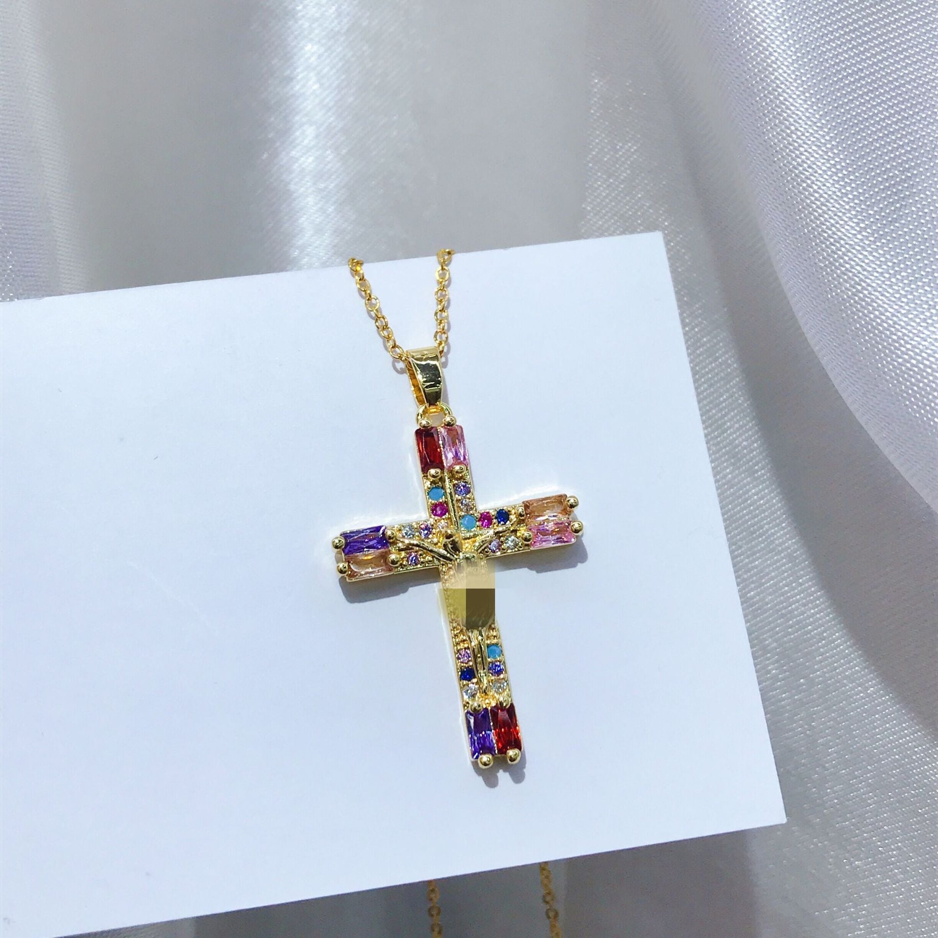 Close-up view of copper cross pendant with gold plating