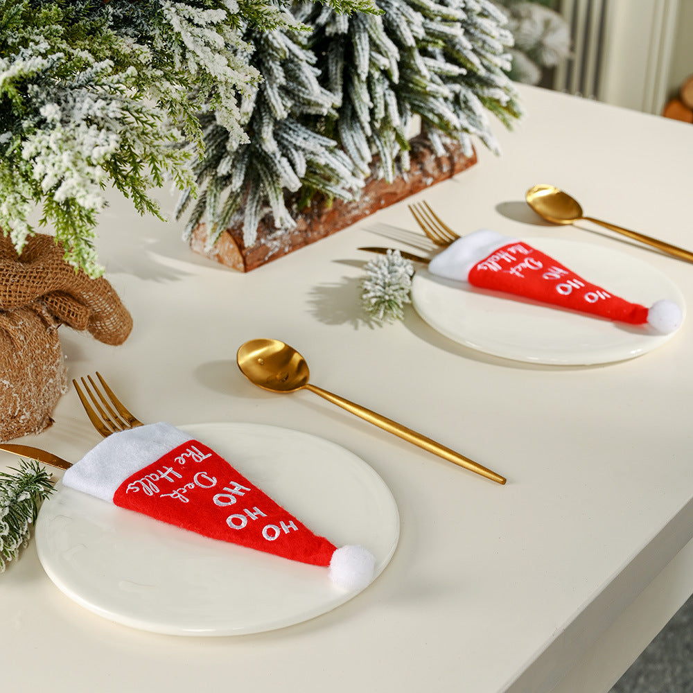 Christmas table setting with festive hat and cutlery decoration