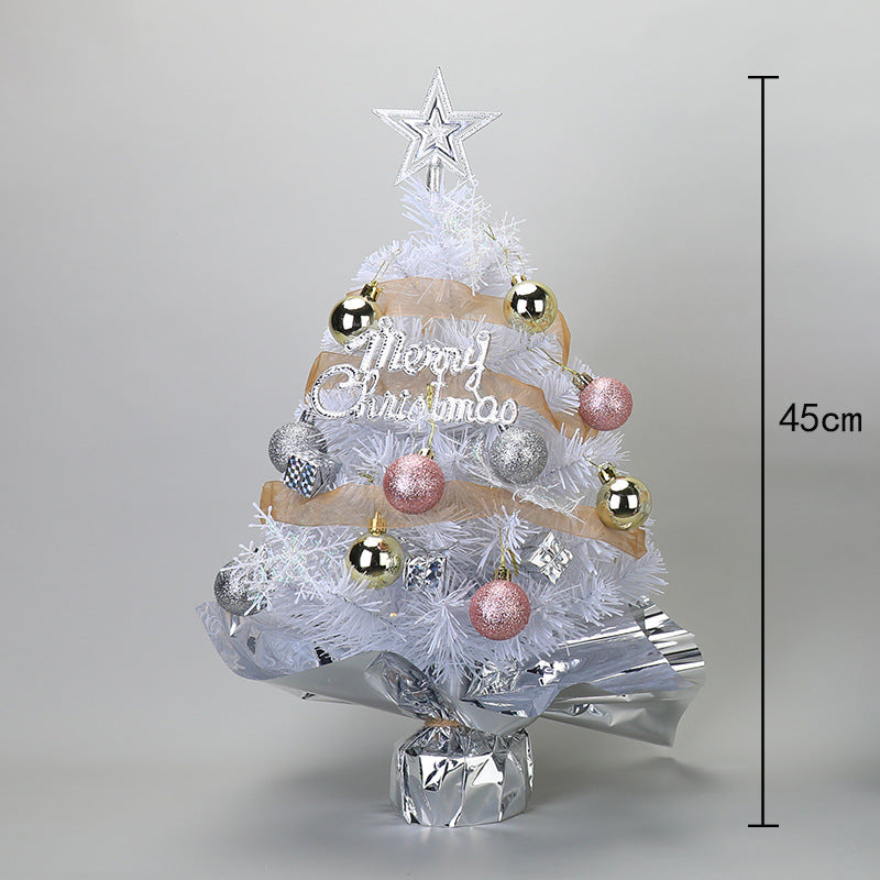 Green desktop Christmas tree with soft lighting for seasonal worship space