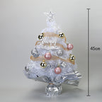 Green desktop Christmas tree with soft lighting for seasonal worship space