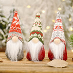 Forest doll ornament with red snowflake hat placed among evergreen branches and pine cones