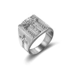 Men's gold cross ring laid on a soft fabric display