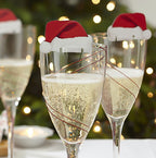 Close-up of red Christmas topper on champagne glass - holiday party accessories