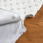 Close-up of white hair sequins on flannel tree skirt fabric