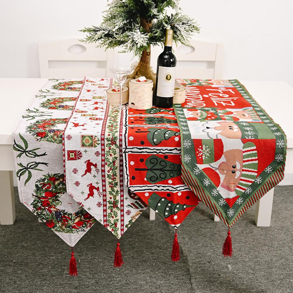 Knit Merry Christmas table runner on decorated holiday dining table with warm fabric texture and festive appeal