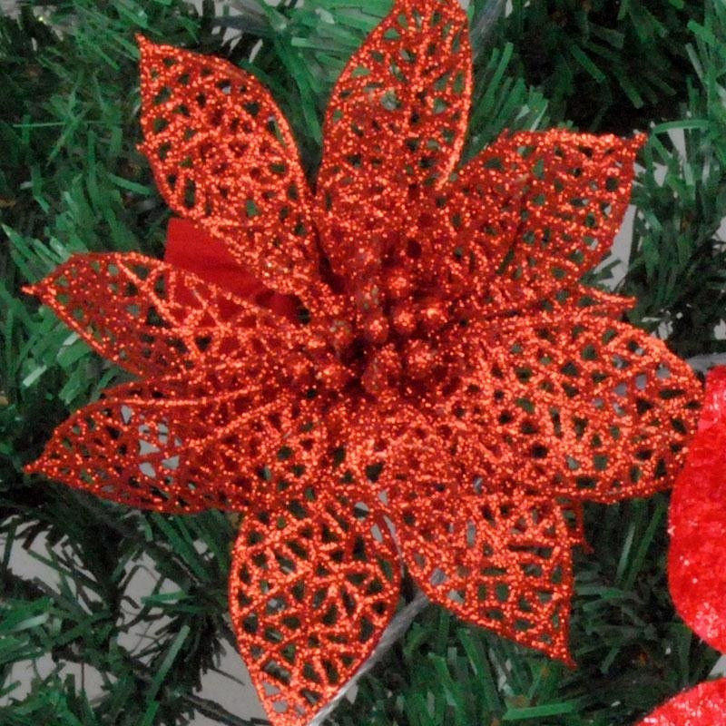 Festive Christmas arrangement with rattan, greenery, and glitter flower ornaments
