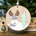 Close-up of hand-painted wooden Christmas pendant with fine details and warm colors