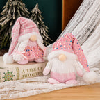 Handmade knitted Christmas couple ornaments displayed on tree