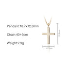 Close-up of polished sterling silver cross pendant showing intricate detail