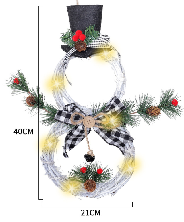Christmas wreath pendant with warm LED lights glowing softly against dark background