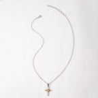 Cross flower pendant displayed against natural background