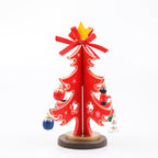 Wooden Christmas tree ornament with holly and festive details painted in red and green