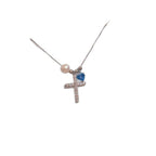 Gold cross necklace featuring pearl and zircon accents close up