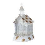 Crystal church music box ornament displayed on a Christmas tree branch with lights