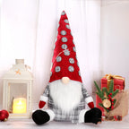 Christmas countdown doll with red hat displayed on evergreen branches - holiday decoration