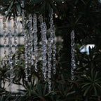 Transparent water drop pendant shapes arranged in a festive holiday setting