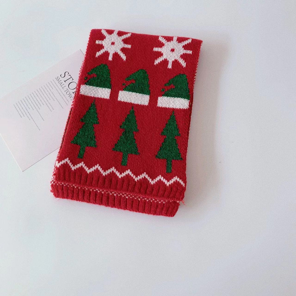 Close-up view of festive embroidered deer and tree design on soft acrylic knit scarf