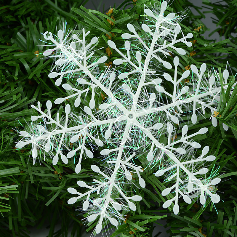 Snowflake ornament displayed on festive holiday mantel arrangement